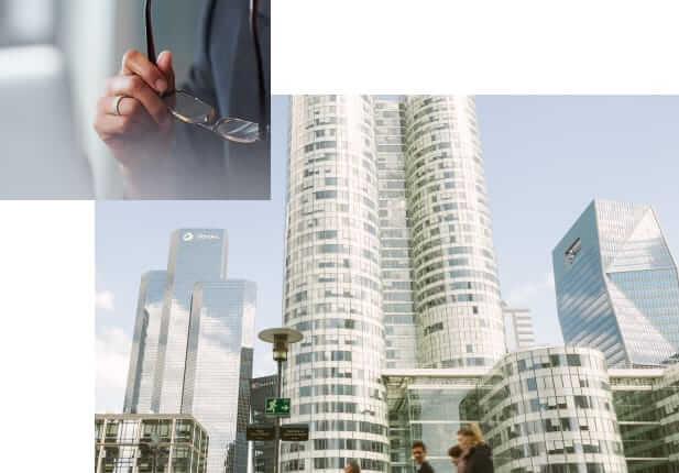 Composite image including close-up photo of hands holding glasses and skyscrapers