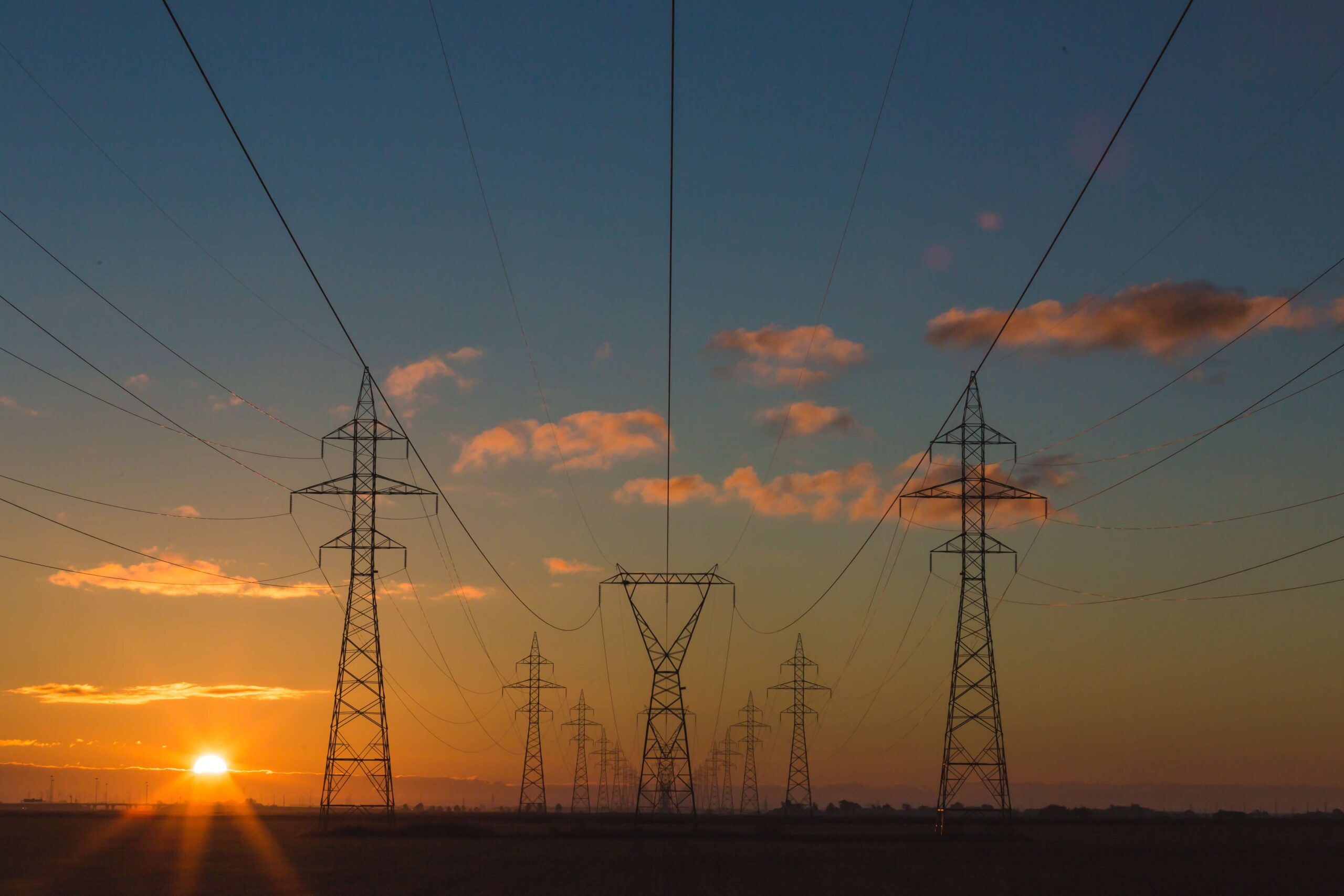 Power lines against sunset landscape.