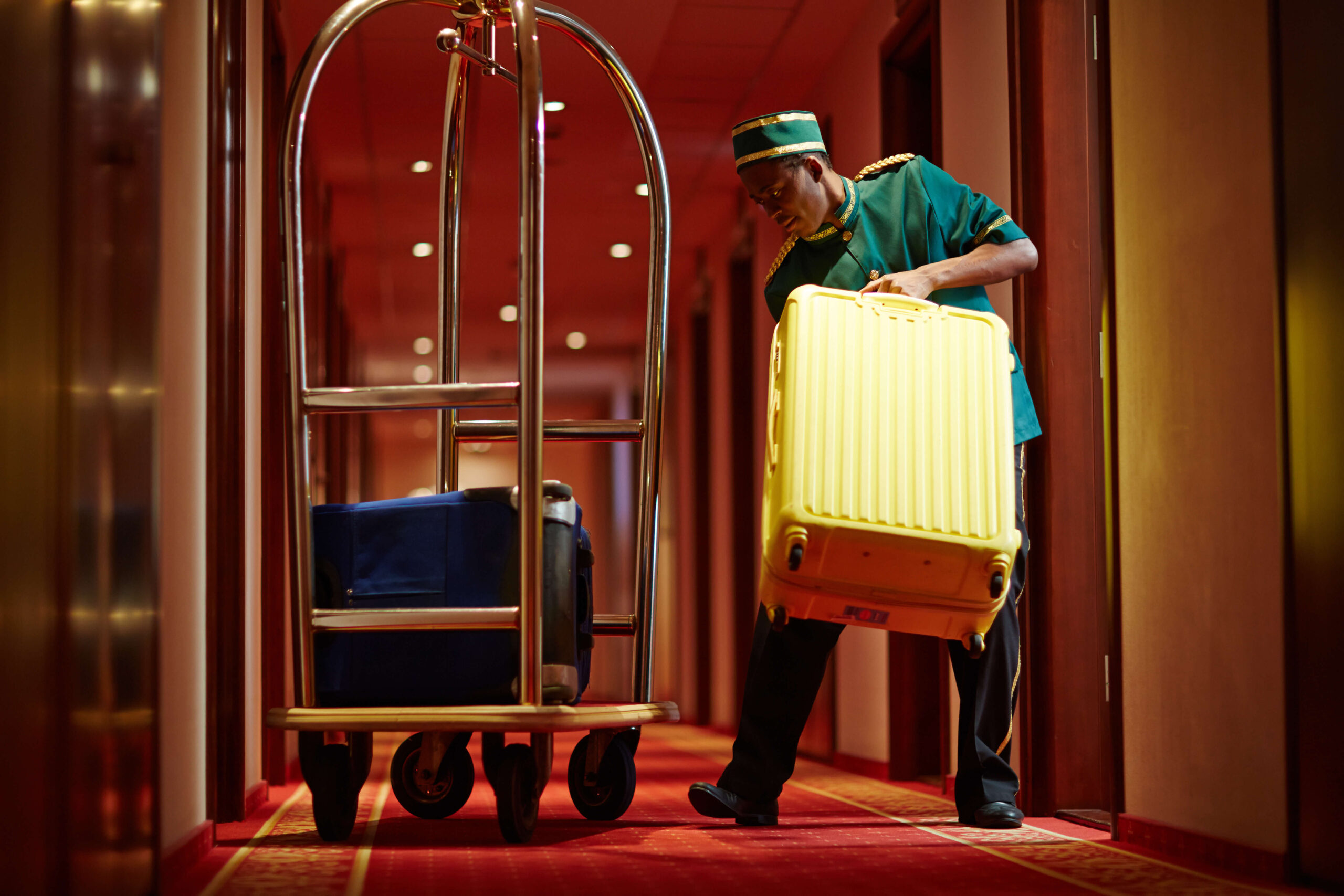 Bellhop loading a cart with luggage.
