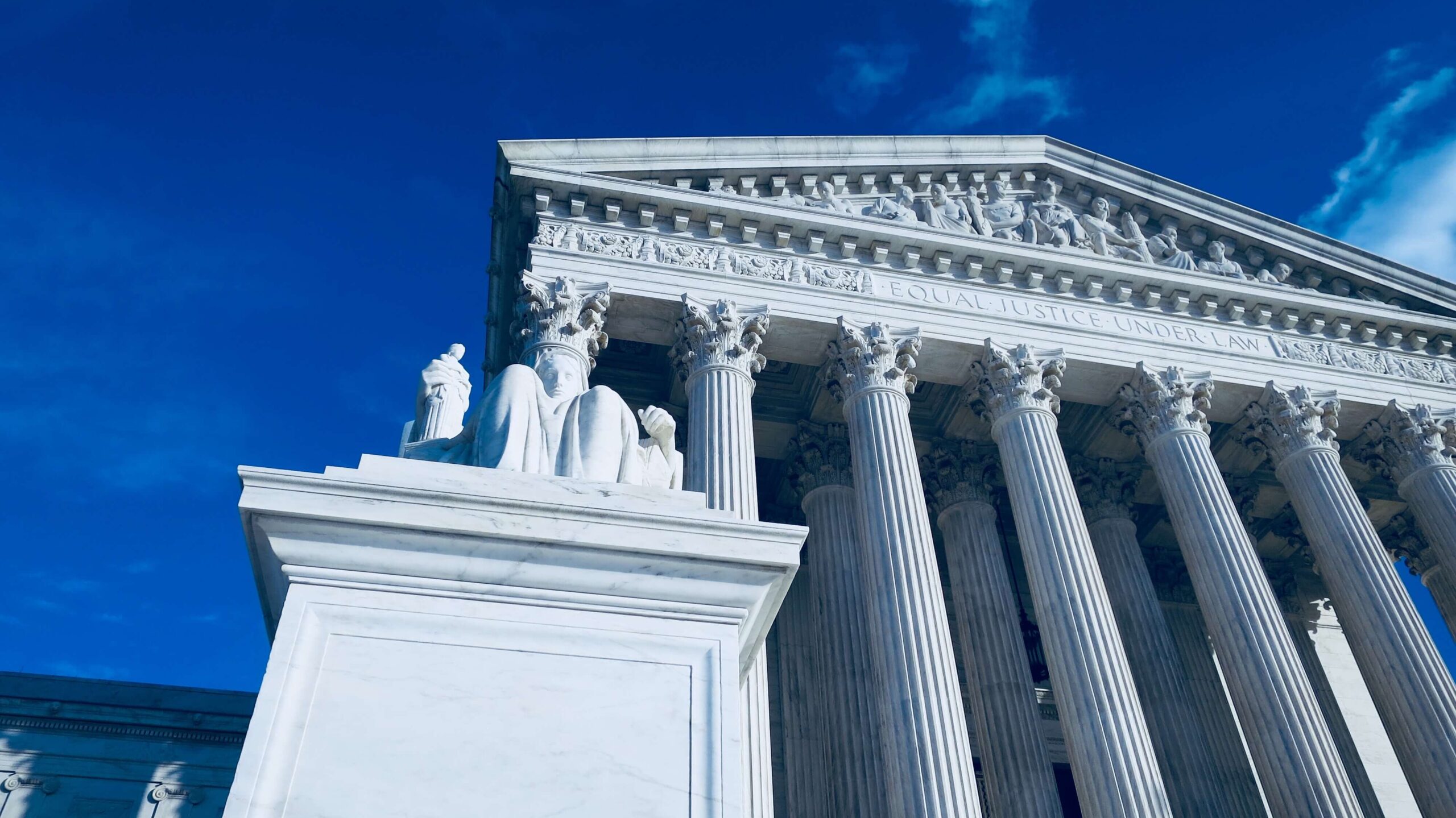 Appellate courthouse with statue.