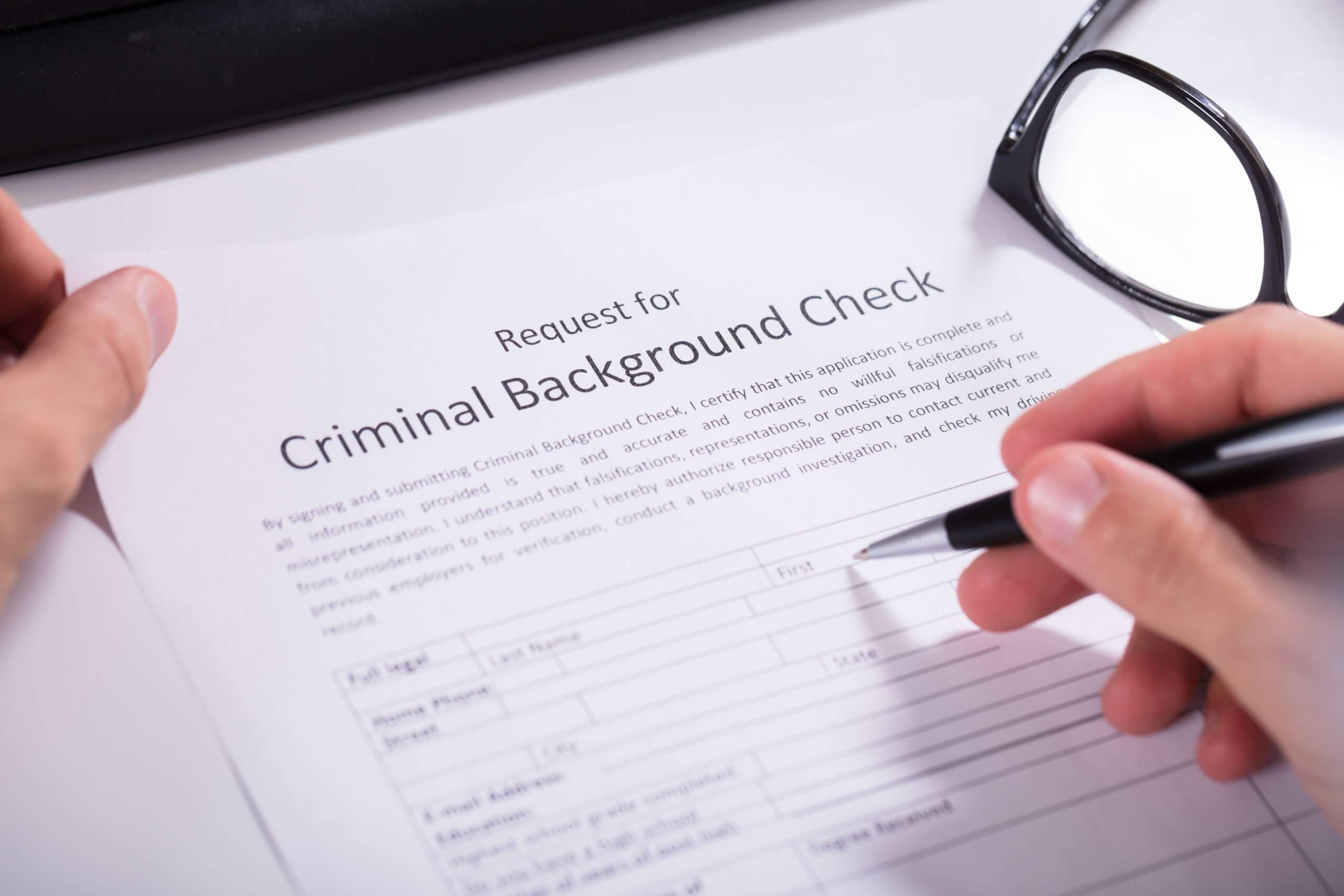 person filling out a request for a criminal background check