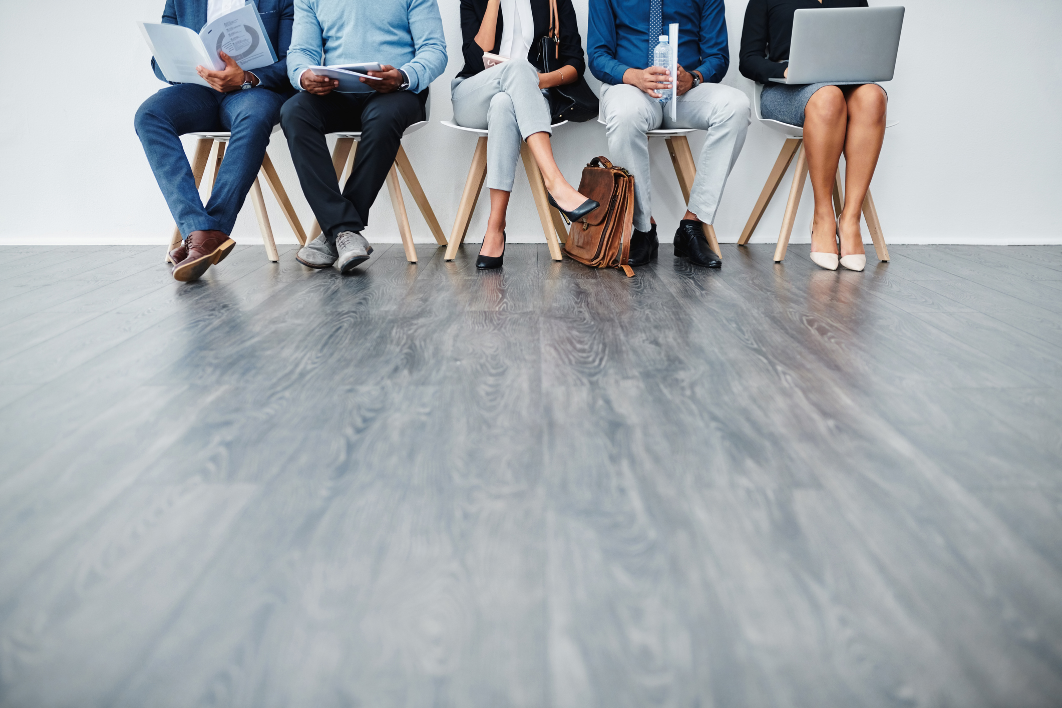 Cropped studio shot of a group of diverse businesspeople waiting in line