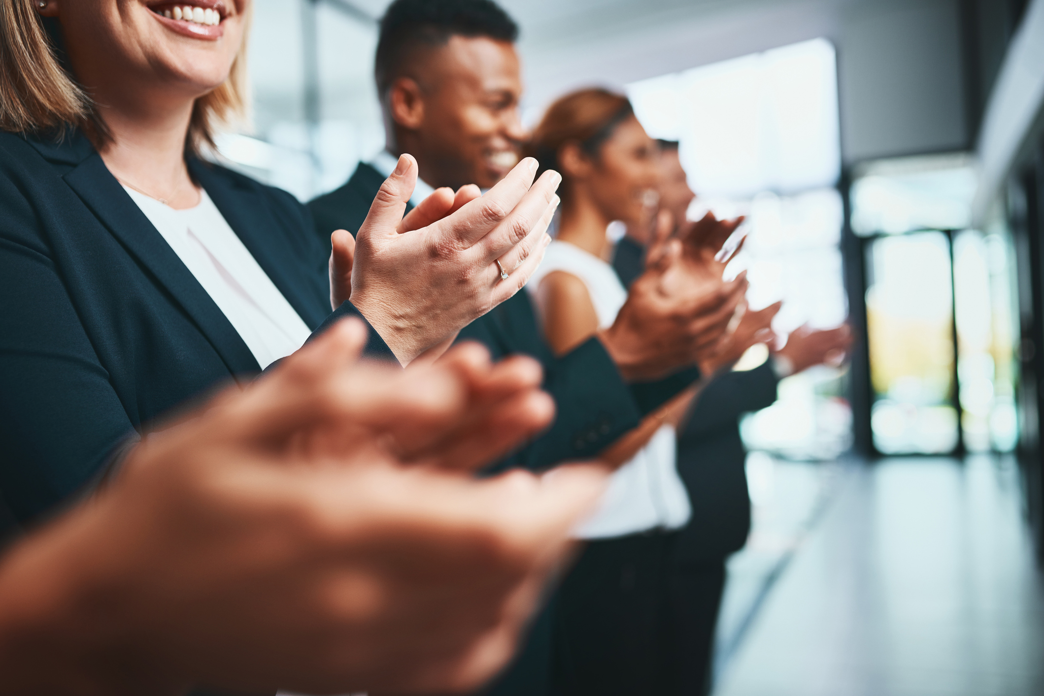 Shot of a group of businesspeople applauding in an office