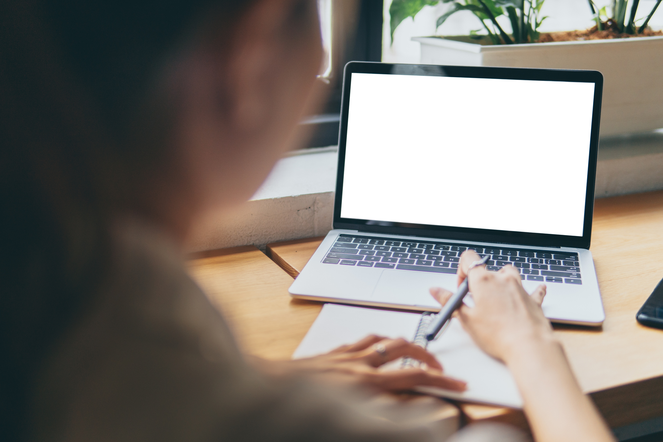 woman hands working with blank screen laptop computer mock up. Working on desk environment.