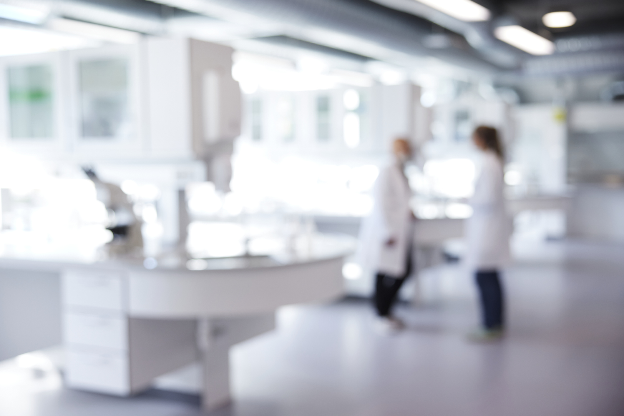 Defocused image of laboratory with two scientist