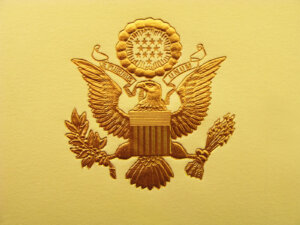 The Seal of the President of the United States is used to mark correspondence from the U.S. president to the United States Congress, and is also used as a symbol of the presidency. The central design, based on the Great Seal of the United States, is the official coat of arms of the U.S. presidency and also appears on the presidential flag. The stripes on the shield represent the 13 original states, unified under and supporting the chief. The motto (meaning "Out of many, one") alludes to the same concept.
