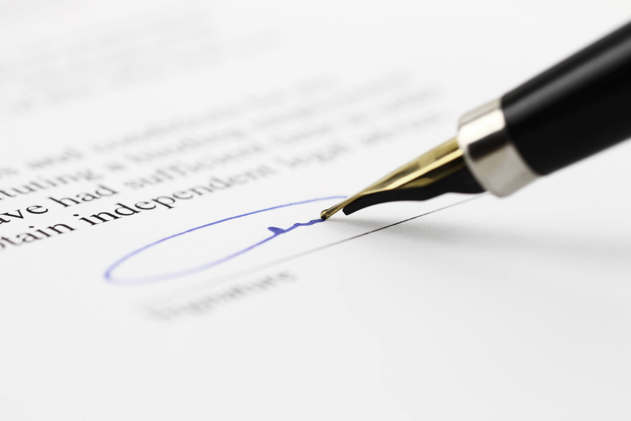 Fountain pen signing a document, close view with center focus