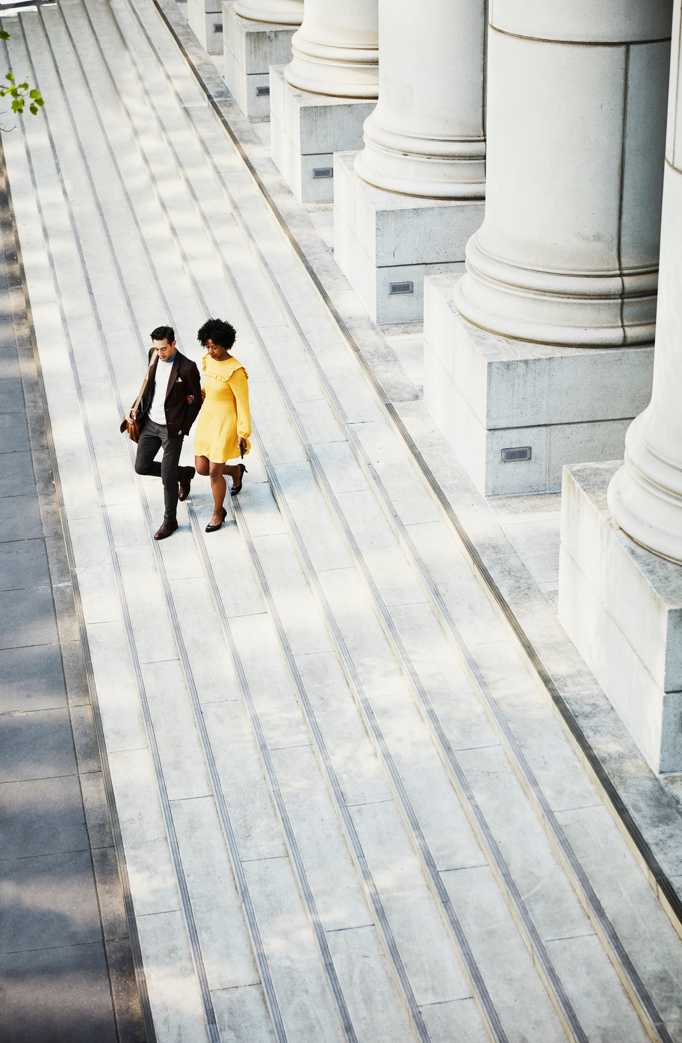 Overhead view of couple walking down steps of building