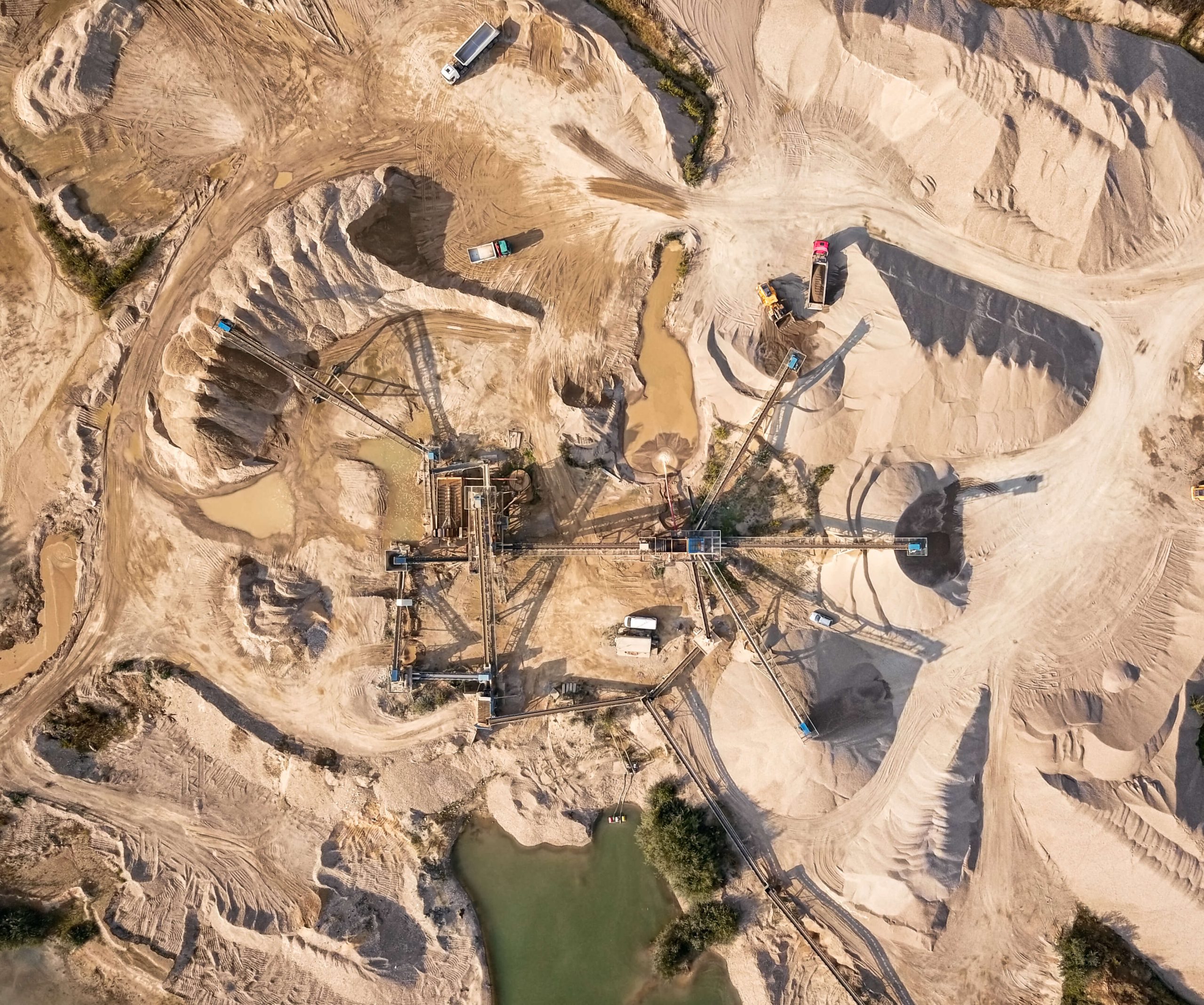 Aerial view of a sand quarry with a massive pile of sand. Capturing a mining operation from above.
